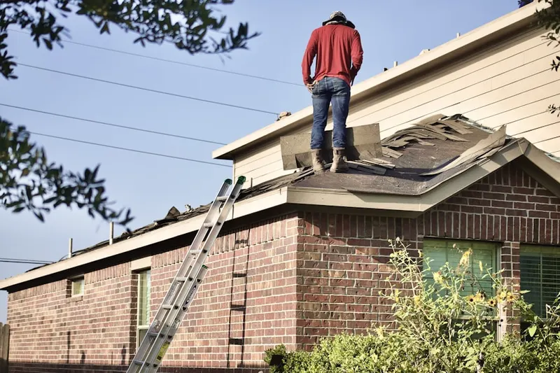 Professional roofer working on a residential roof in Brewster Heights